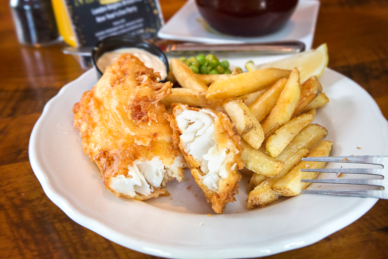Served with chips (aka fries), the moist fish has a crisp golden coating.