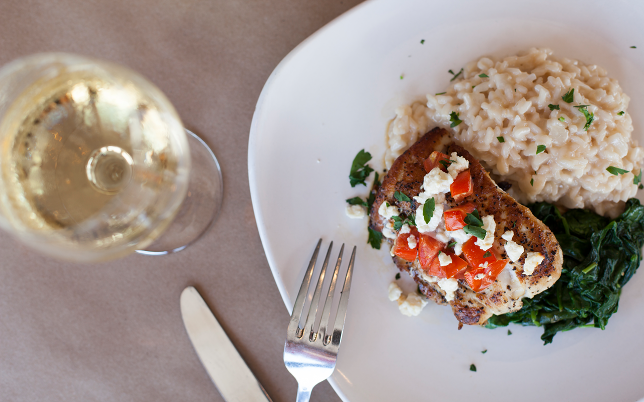Sola Bistro's pan-seared grouper Mykonos is served with sautéed spinach, tomatoes, feta and tasty risotto.
