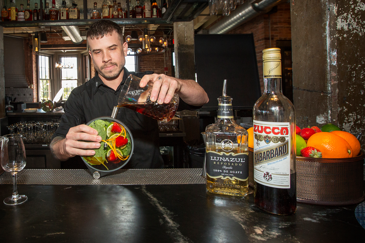 Bartender Ryan prepares what the restaurant calls an Infused Duo, mixing Lunazul Reposado (tequila) and Zucca Rabarbaro (amaro) with strawberry, lime, basil and agave.