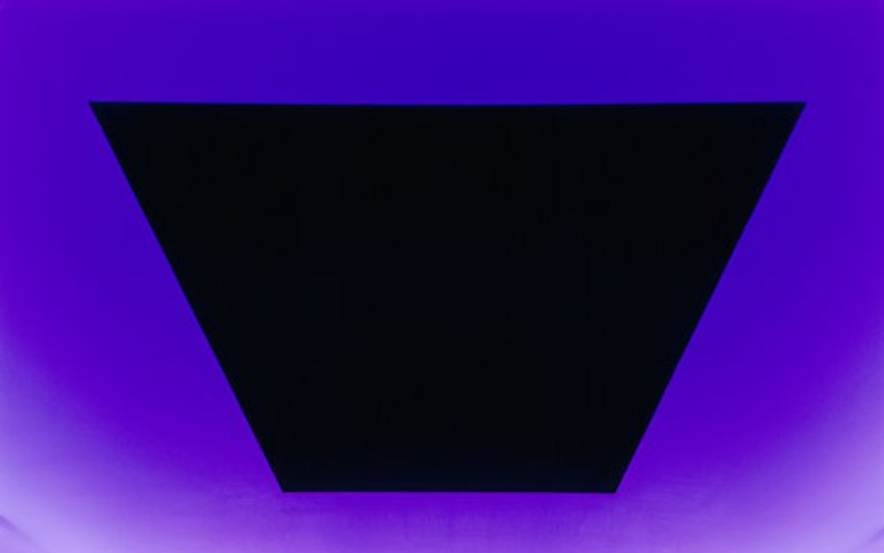 Turrell’s Skyspace at Pomona College in California, Dividing the Light, bathed in violet light at night.