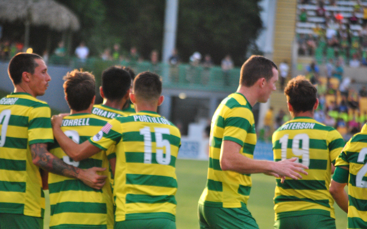 Teammates congratulate Alex Morrell on his first of two goals in the match.