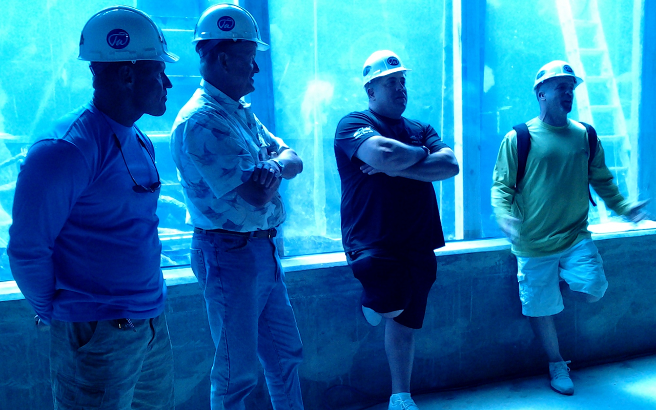 Keith Overton, Guy Harvey, Wade King and Brett Raymer discuss RumFish Grill & Bar's aquarium.