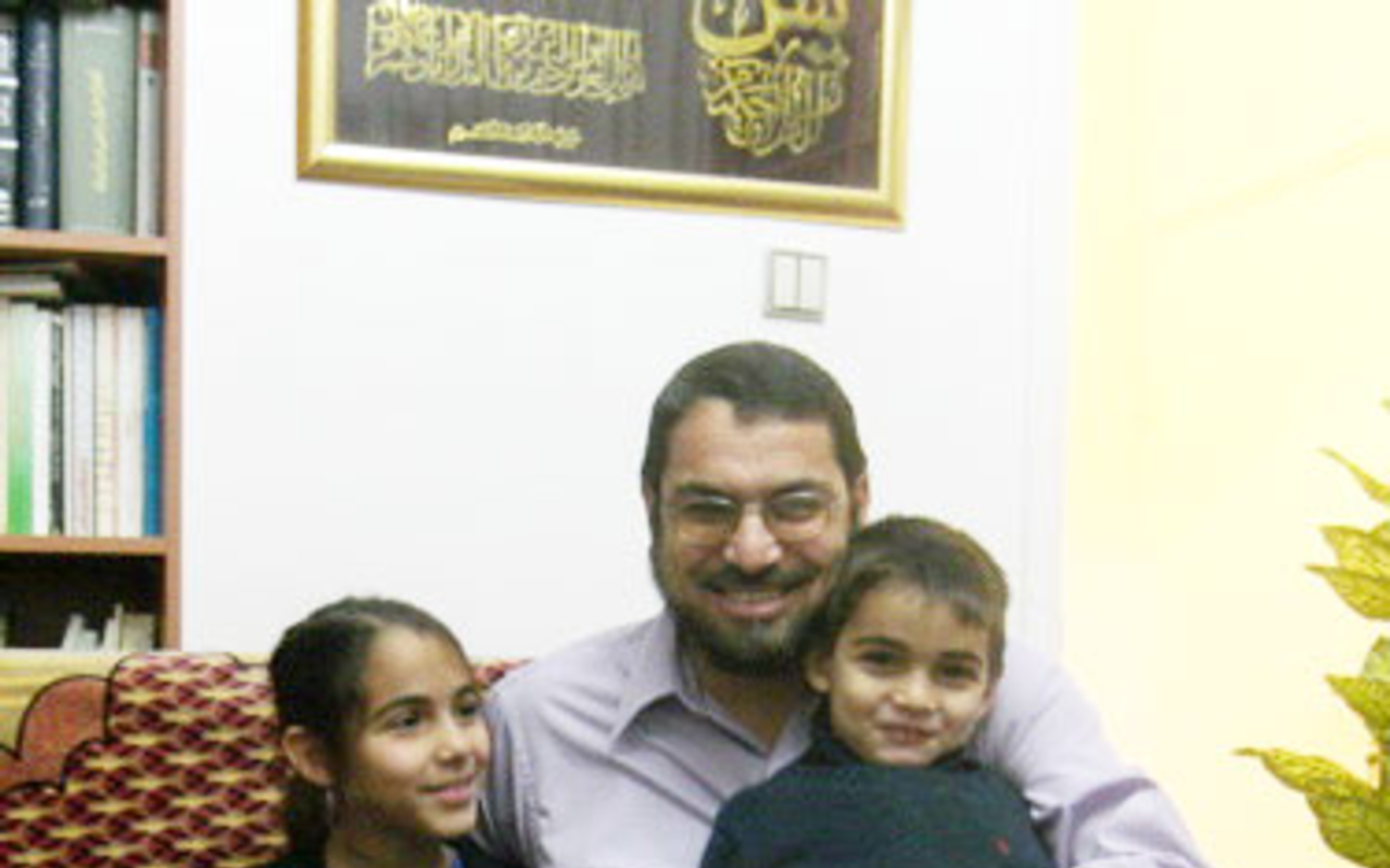 AT HOME: Hammoudeh at his Ramallah home with two of his six children, Muhammad and Alaa.