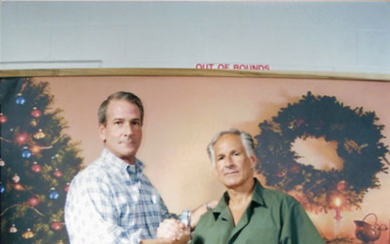 GREETINGS FROM PRISON: John Flahive and George Martorano pose for a holiday photo in front of a faux domestic backdrop at Coleman prison.