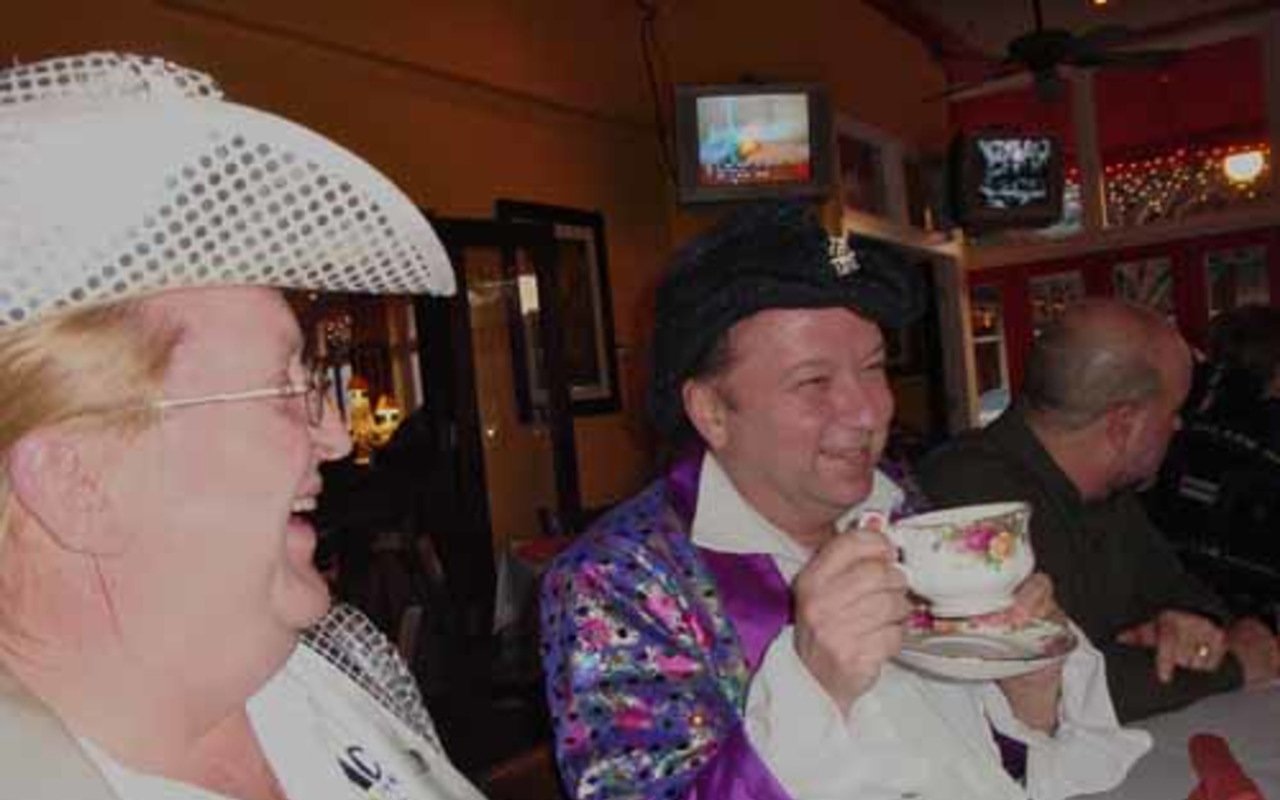IT'S NOT WATER: Mark Bias explains his trademark teacup at Streetcar Charlie's while Carrie West looks on.
