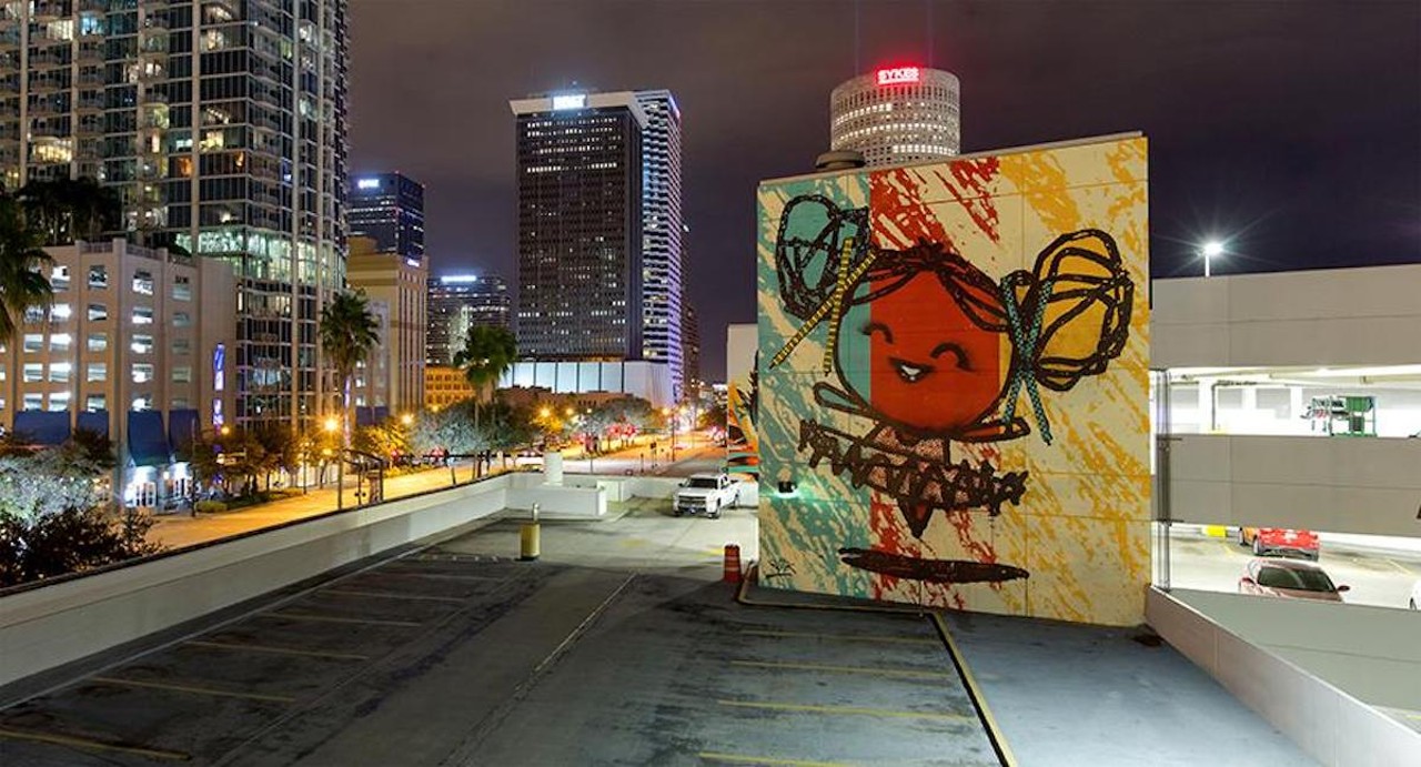 Tes One and Bask encourage Tampa to stay curious
800 N Ashley Dr., Tampa
It’s not easy to make a parking garage look good, but Tes One, Bask (stylized “BASK”), and the Vitale Brothers did a bang-up job when they painted downtown Tampa’s Poe parking garage in 2015. It took one month, a team of eight painters and over 175 gallons of paint to complete the Stay Curious murals, of which there are five. Together, they remind visitors to the Tampa Museum of Art and Glazer Children’s Museum to stay curious, dream big, reflect, play, keep learning, and experience the arts in downtown Tampa.Photo via City of Tampa