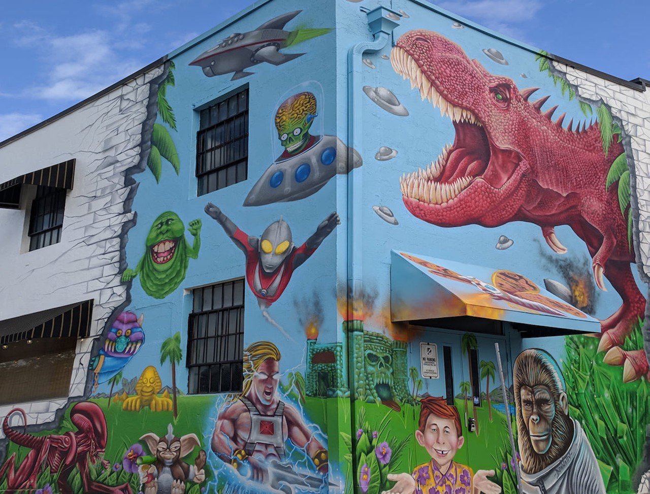 Flashback to your childhood with 1970s-1990s pop nostalgia in St. Pete’s Edge District
269 16th St. N, St. Petersburg
The big red dinosaur at on 16th Street made a lot more sense when the building was a toy store back in 2019, but Cultosaurus the toy store now lives on Central Avenue. Cultosaurus the mural, which features “Ghostbusters,” “Planet of the Apes,” and Mad Magazine imagery, is a tribute to 1970s-1990s pop culture that we hope stands the test of time.Photo via cultosaurus/Facebook