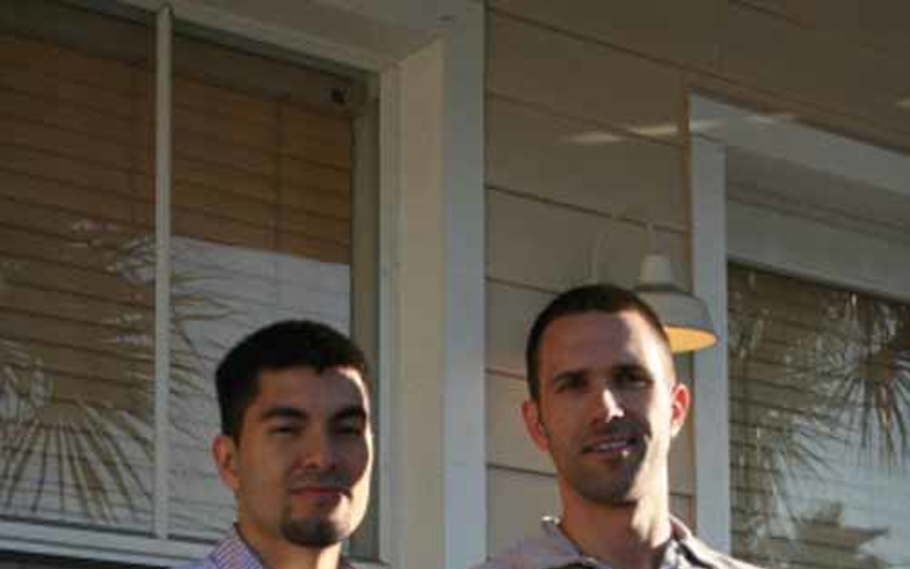 Jose Garboza and Tony LaColla on a porch at their Ybor condo.