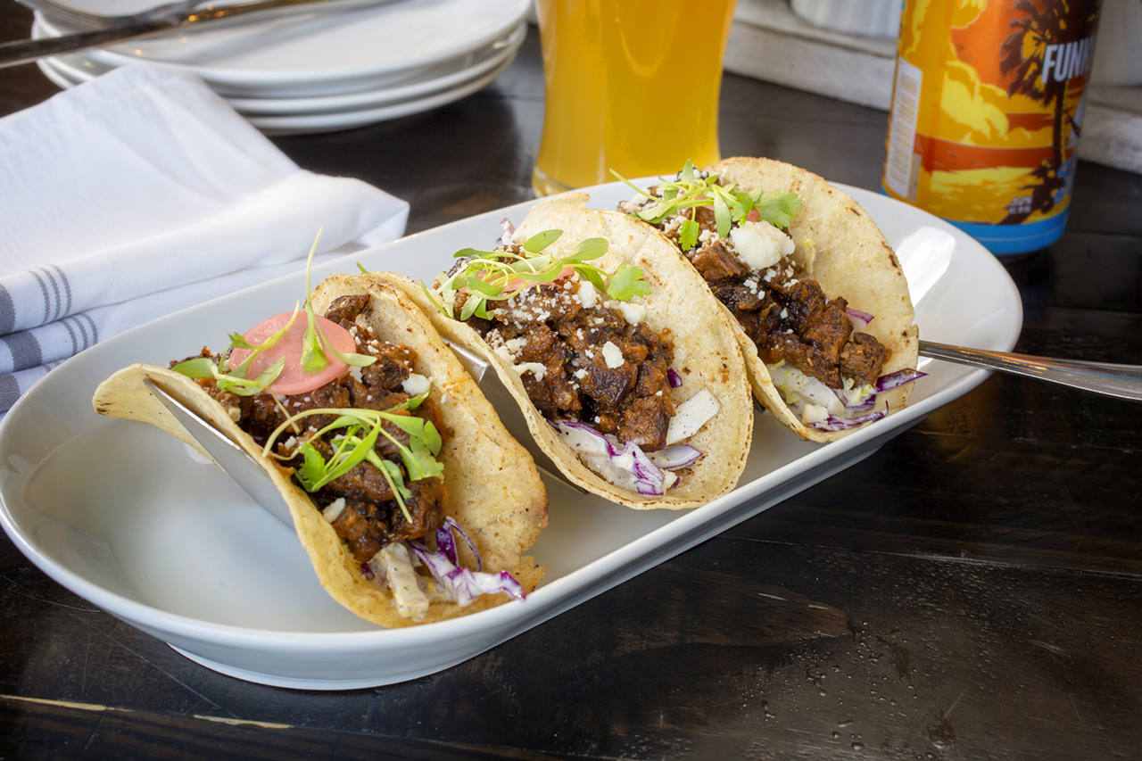 The trio is composed of marinated skirt steak, pickled radish and slaw, charred salsa, and cotija cheese.