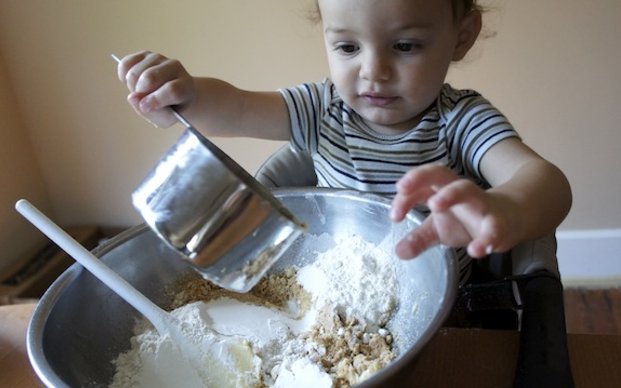BABY BAKES: Eli at work mixing up S’more Squares.
