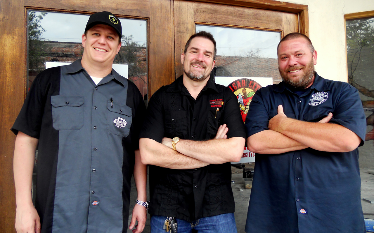 GLAD SCIENTISTS: (L-R) Cigar City Brewing’s vice president Justin Clark, founder Joey Redner and Todd Strauss of Cigar City Cider and Mead stand in front of the company's cider and mead facility.