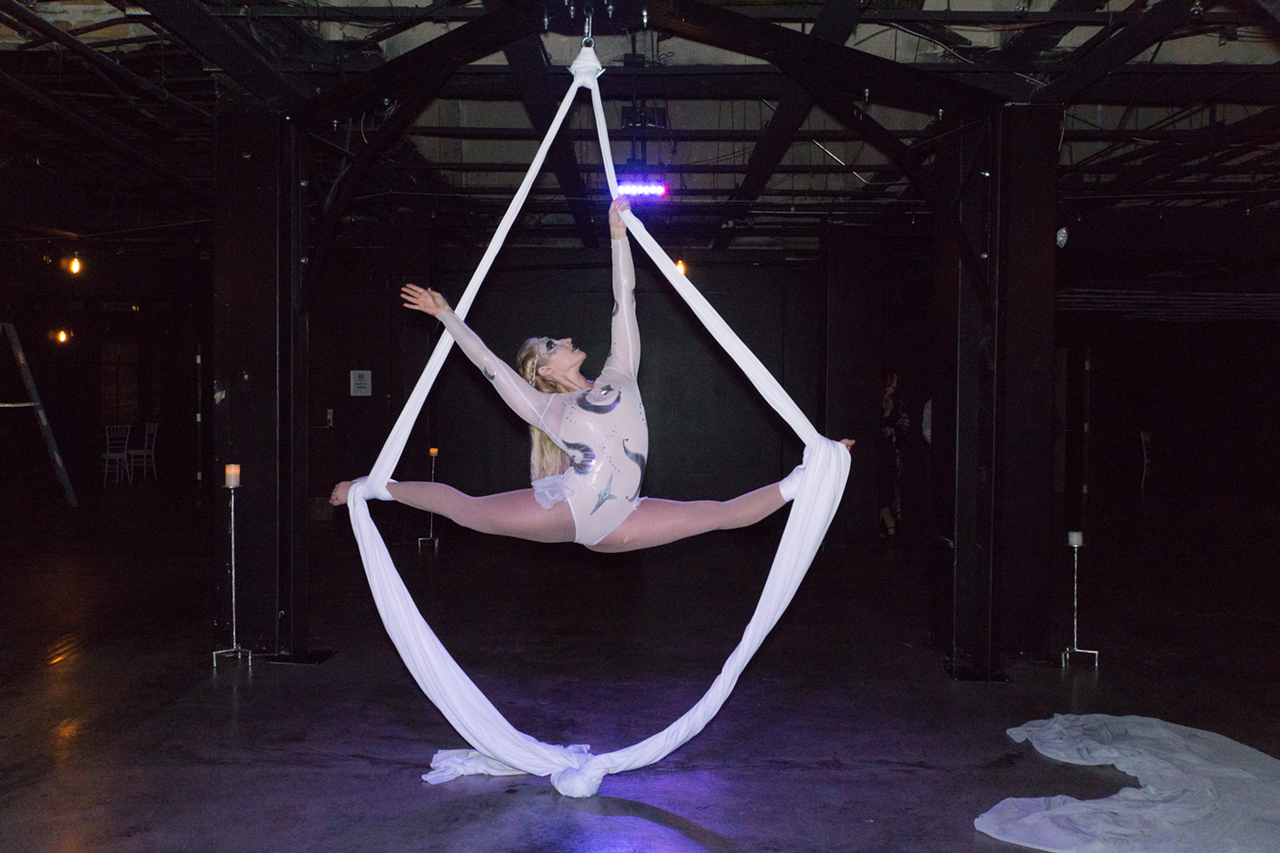 Emily Torres, aerialist and contortionist, awaits successful guests at the Spirit Bar.