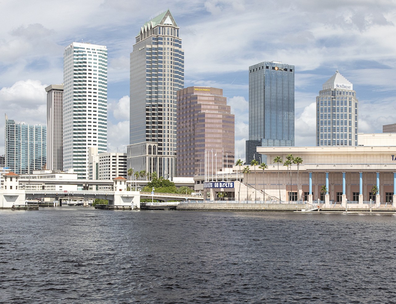NOW
Downtown Tampa skyline and Platt Street Bridge
View from Davis Islands, 2020
Current plans call for the extension of the Riverwalk to the west side of the river to continue it northward, connecting neighborhoods on both sides to downtown. The most remarkable change in these two photos that span 60 years, is the difference in the skyline. In the Burgert photo, the First National Bank (center left) with the flag on top was 13 stories high and looks to be the tallest building in downtown. It pales in comparison to the modern skyscrapers. Built in 1990, 100 Tampa North, in the same position in the new photo, is 42 stories high.