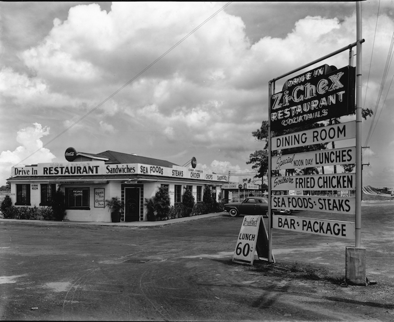 THEN
Zi-Chex Drive Inn Restaurant
3801 Gandy Boulevard, 1952.
After World War II drive-in restaurants were the rage and Zi-Chex joined the fray in 1952. Unlike other such restaurants, Zi-Chex also had a lounge and served cocktails. Lunches were $0.60, specializing in southern delicacies like fried chicken, seafood, and steaks. Being in close proximity to MacDill Air Force Base was a plus, and they were convenient to the Tampa Jai Alai Fronton to the south and Derby Lane dog track to the west, sometimes snagging hungry gamblers.