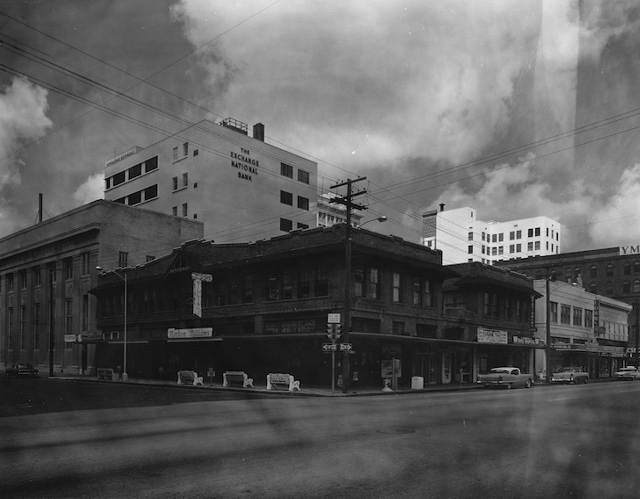 THEN
Morton Williams store and the Exchange National Bank
The Pettaway Building on the corner of Florida Avenue and Twiggs, home to the downtown location of Morton Williams, was constructed in 1912. The Tampa Furniture Company and The Tampa Photo and Art Supply Company were the first tenants. This Burgert photo is untitled and undated but was most likely taken in the early 1960s given the model of the cars and Tampa Coin Exchange in the image. It is another example of a photo in the collection missing the typical Burgert quality and signature.