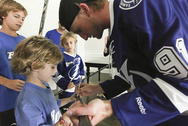 Tyler and Colin watch in admiration as Stamkos signs Nicholas' hockey stick - Nicole Abbett