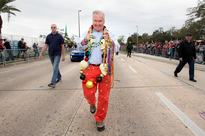 Tampa Mayor Bob Buckhorn adorned in large skull beads and red skull and crossbones pants threw beads and shook hands with his citizenry on Saturday. - Chip Weiner