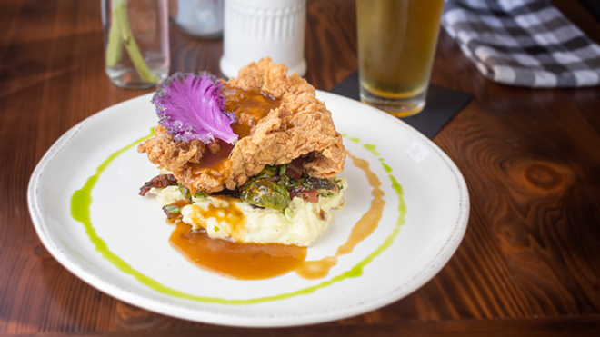 Fried chicken arrives nestled on a bed of mashed potatoes and Brussels sprouts. - Chip Weiner