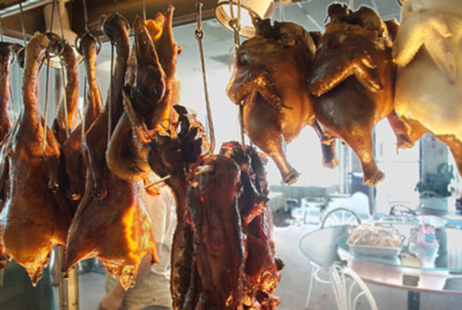 HOOKED ON A CEILING: The barbecued birds in China Yuan hang on display for diners. - Lisa Mauriello