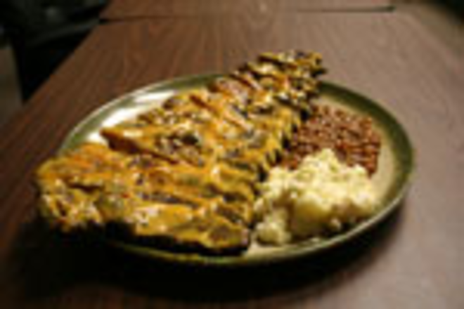 A GOOD RIBBING: A rack of Connie's meaty perfection, complete with potato salad and beans. - Max Linsky