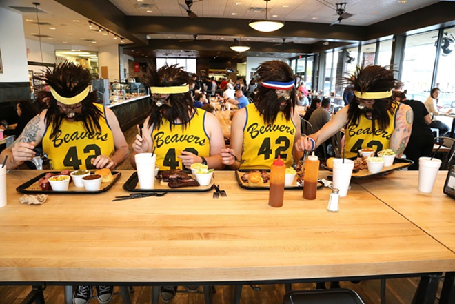 The fast-casual 4 Rivers features communal tables for sit-down dining. - Drunk Camera Guy