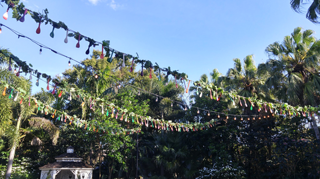Strings of lights and garlands that feature different colored spoons hang above the festival's grounds. - Meaghan Habuda
