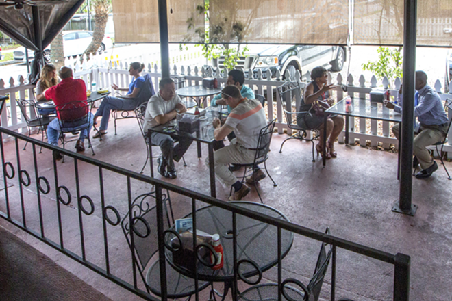 Diners chow outside along Pollo Garden's rear patio. - Chip Weiner