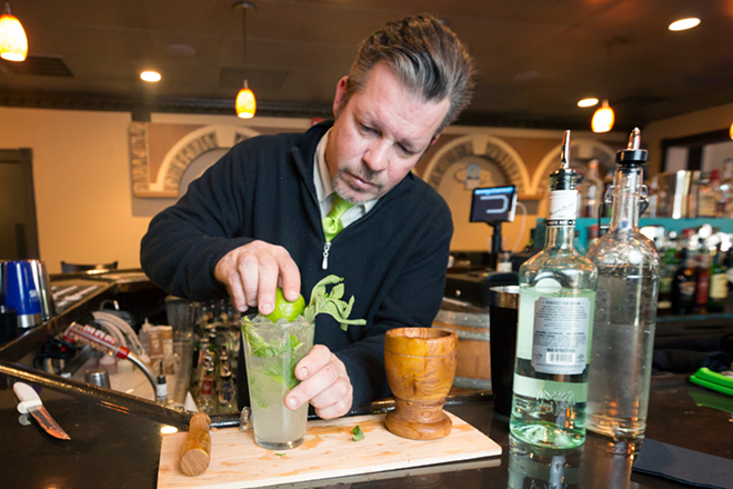 Beverage manager Christopher Berge prepares a mojito, the Lutz restaurant's signature Cuban cocktail. - CHIP WEINER