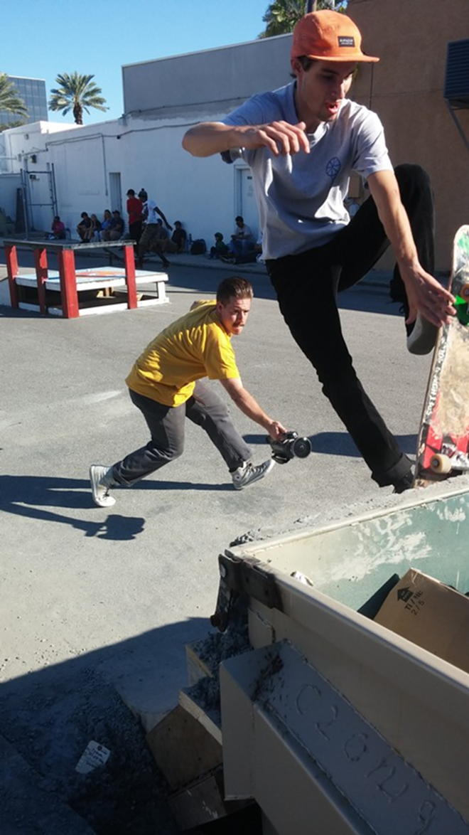 During skate contest on Saturday's celebration of Freshly Squeezed's two-year anniversary, filmmaker @softhoagierolls_ captures a skater performing a trick on the makeshift concrete quarter pipe. - Chris Girandola