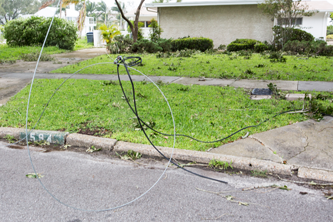 Officials urged caution about downed power lines as people moved back into their homes after evacuation. These wires were on Davis Islands in South Tampa. - Chip Weiner