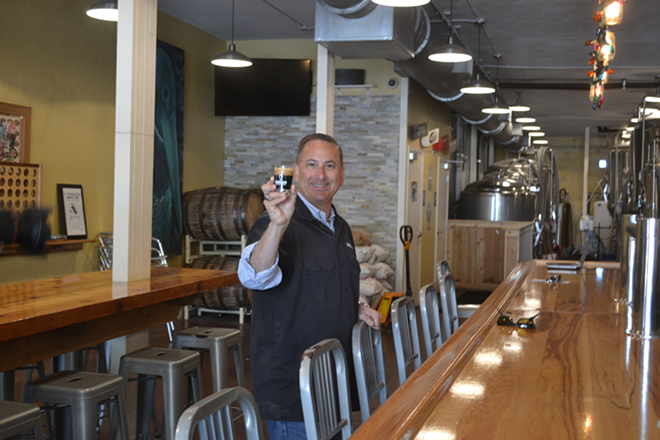 St. Petersburg Mayor Rick Kriseman holds a sample of St. Pete Brewing Co. Coconut Black Ale. - Ryan Ballogg