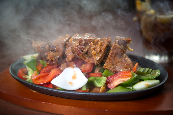 Similar to fajitas, panang duck arrives hot and sizzling with zucchini, bell peppers and coconut meat. - Chip Weiner