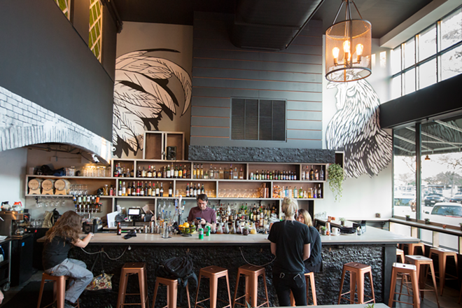 A handsome bar complements the space's welcoming, chic atmosphere. - Chip Weiner