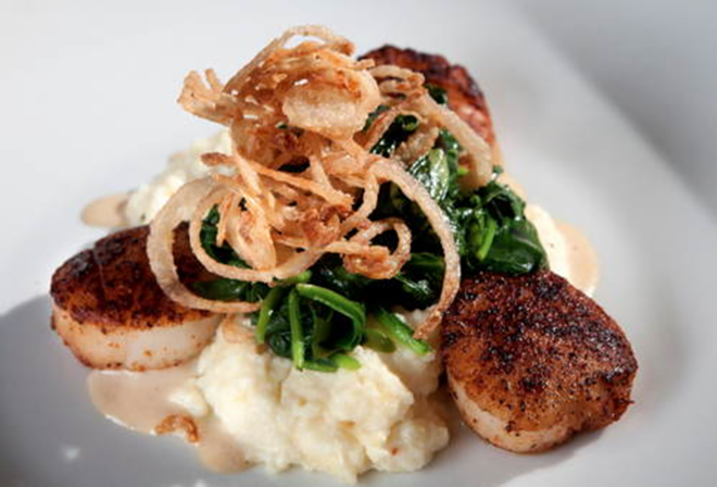 Spice-rubbed scallops atop spicy, cheesy grits and drizzled with red-eye gravy at Mise En Place. - Chip Weiner Photographic Arts