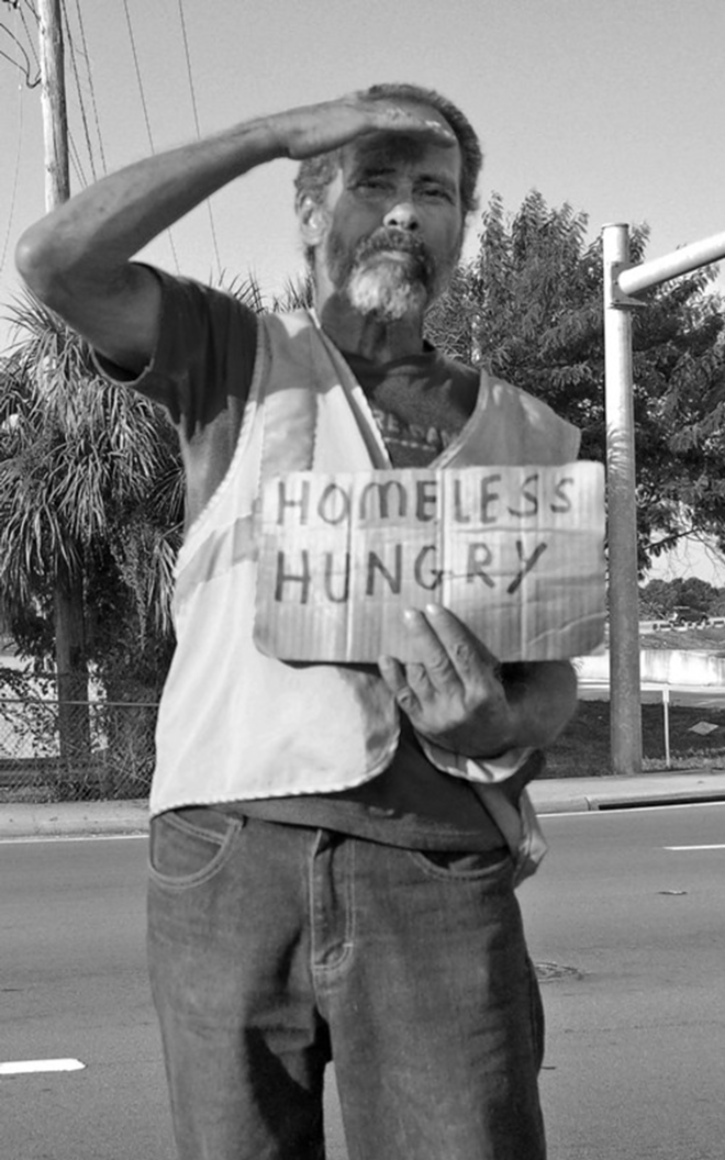 A homeless man asks for help in Tampa. - Lydia Harvey