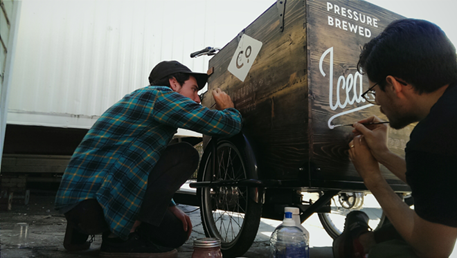 Stover and Sincich paint the keg box of Commune + Co.'s new tricycle in Ybor. - Ray ROa