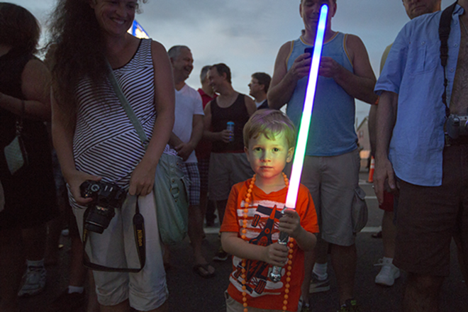 Dillan, almost 4, shows his pride with his light saber. - Chip Weiner