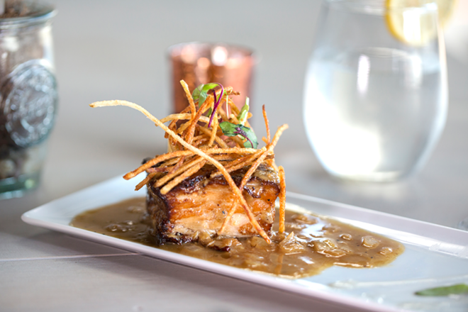 Duck fat-braised pork belly, showcasing shoestring potatoes, Madeira reduction and saffron oil. - Chip Weiner