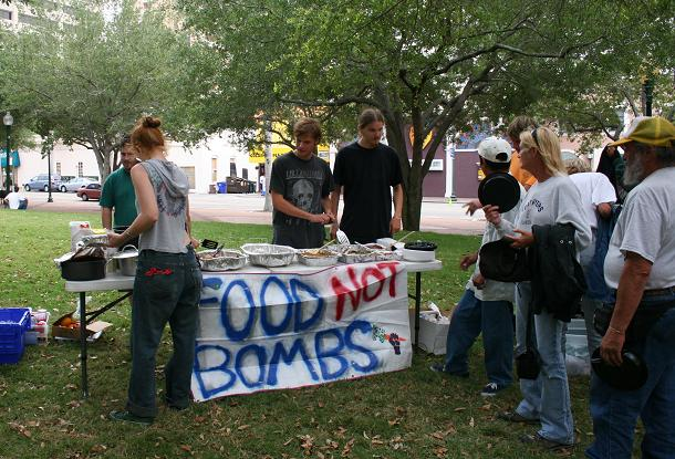 A Food Not Bombs chapter offers food to the homeless in a park. - Wikimedia Commons