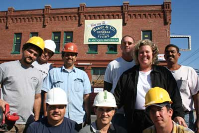 GOLDEN TOUCH: Barbara Baker surrounded by her "family," construction workers who have spent the past year restoring the 1907 Gold Nugget building for her. - Wayne Garcia