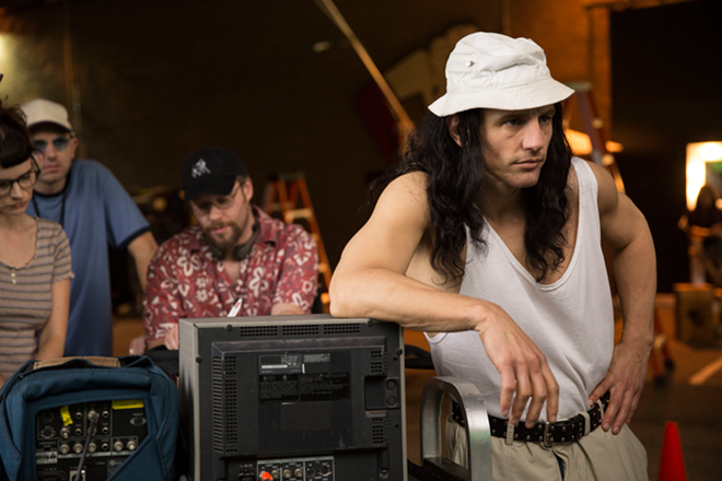 Jason Franco (far right), as Tommy Wiseau, directs a scene from The Room while (from left) Kelly Oxford, Paul Scheer and Seth Rogen wait for magic to happen. - A24 Films