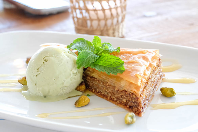 The baklava's parchment-like paper thin phyllo is brown and crisp, the nutty spice filling sweetened with honey is gooey and luscious without throwing the whole thing out of whack. - MELISSA SANTELL