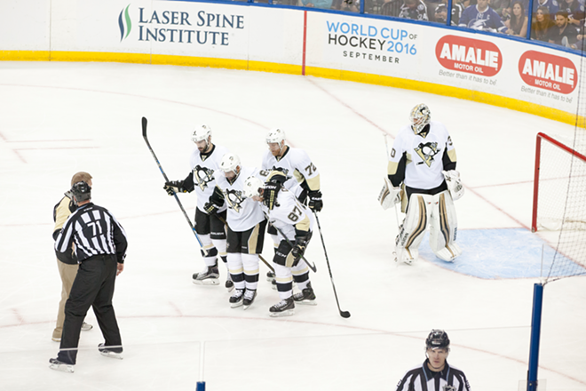 The Penguins' Trevor Daley is helped off the ice by Sidney Crosby and Justin Shultz in the 2nd period. - Nicole Abbett