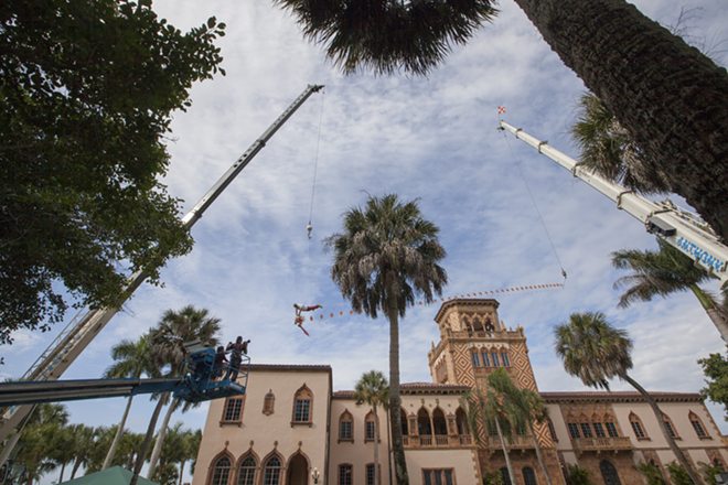 Chinese artist Li Wei soars 40 ft in the air, using the Cá d’Zan as a backdrop for his art at The Ringling on Monday, Nov. 17, 2014. - Nicole Abbett