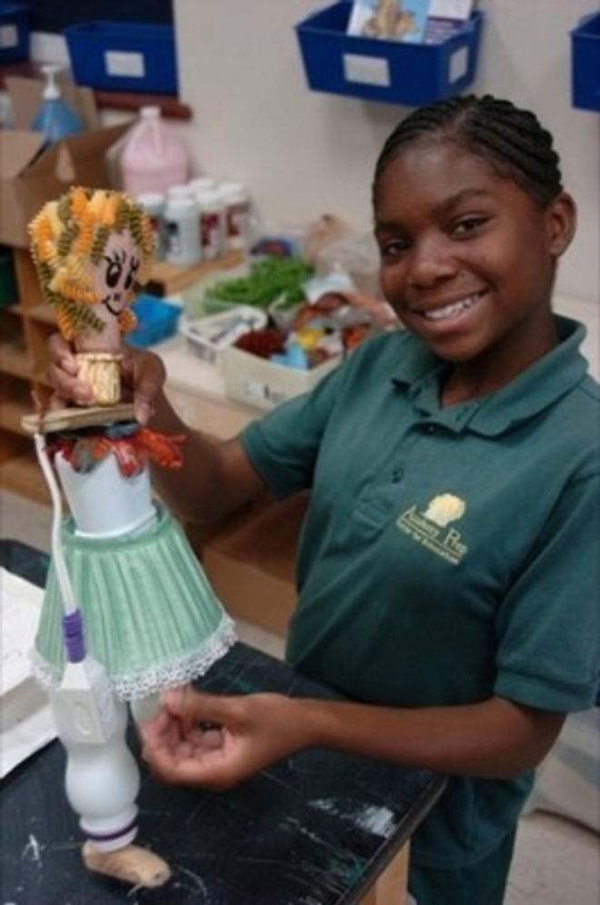 Academy Prep student Mikeisha Wilks with her light-bulb marionette. - Dan Weisberg