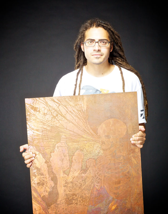 Jon Didier with one of his copper etchings. - Todd Bates