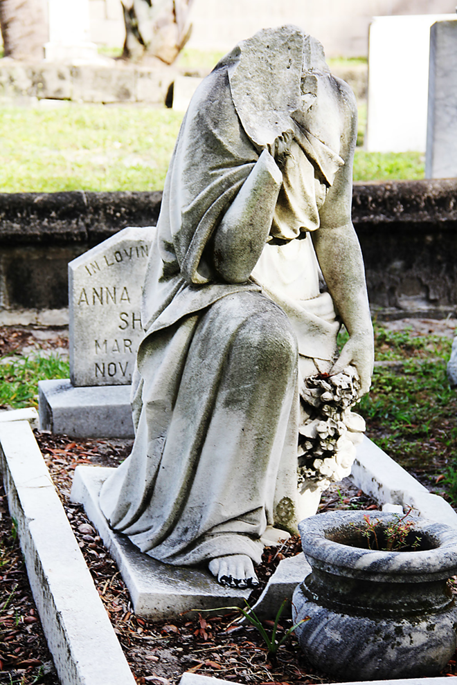 VANDALIZED: Valeria Butzloff’s decapitated statue, one of the most notorious examples of damage at Tampa’s Oaklawn Cemetery. - Daniel Veintimilla