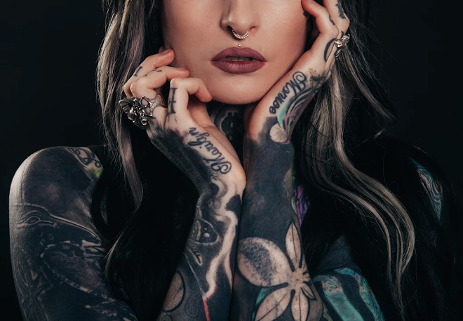 woman holding her face with tattoos - unsplash