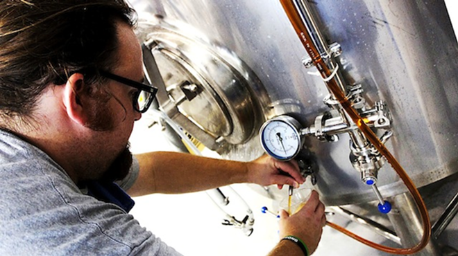 Big Storm Brewing Company's Mike Bishop pours some of their first batch of brew. - Arielle Stevenson