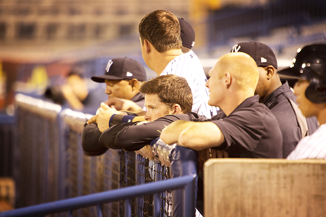 Tampa Yankees hanging out at the dugout fence. - Chip Weiner